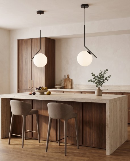 Czarna lampa wisząca z białym szklanym kloszem nad wyspą kuchenną w aranżacji